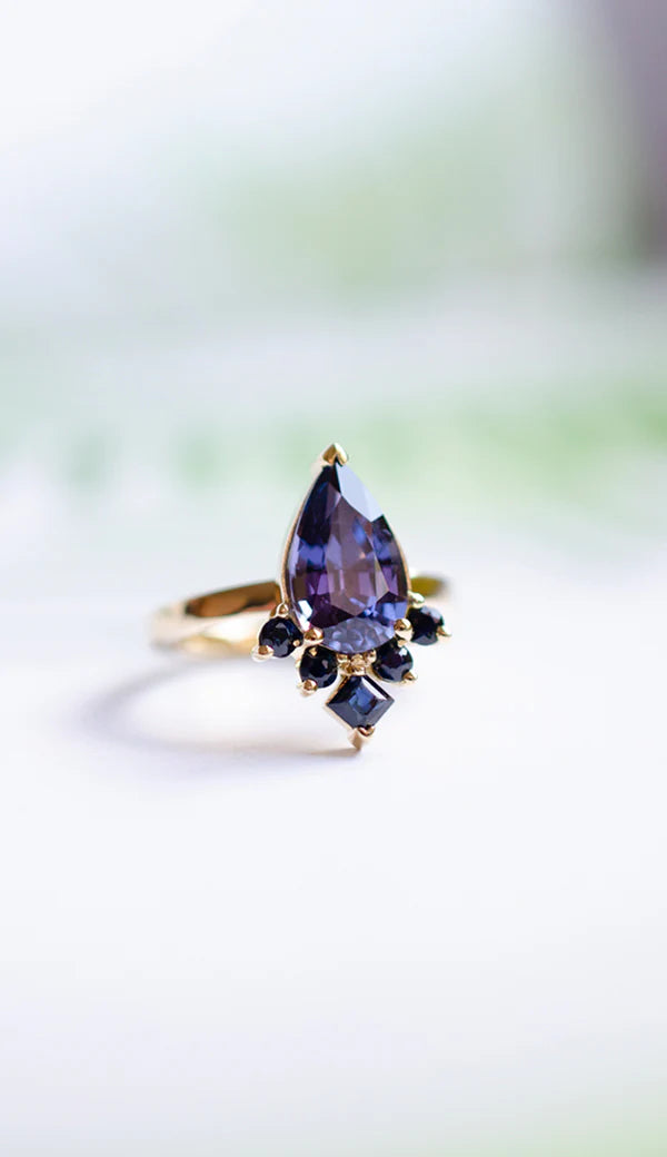 Mei-Li_Rose_bespoke_jewellery_london_purple_sapphire_engagement_ring_pear_cut_custom_ring.webp